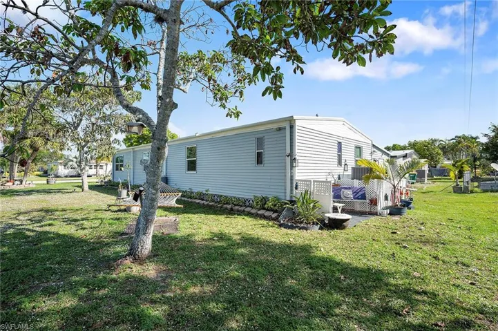 View of side of home with a yard