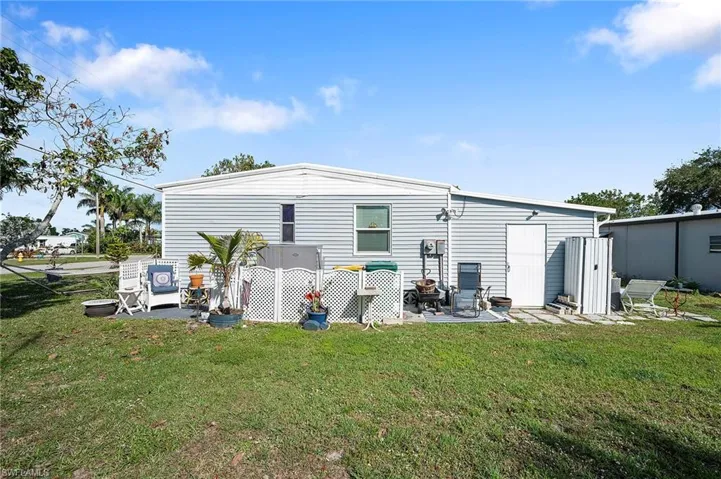 Rear view of property featuring a lawn