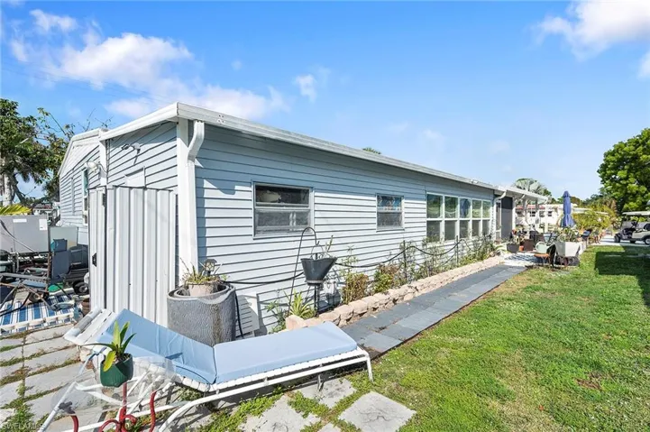Back of house with a lawn
