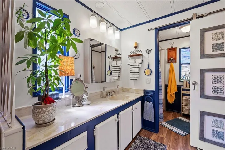 Bathroom featuring wood-type flooring, vanity, and a textured ceiling