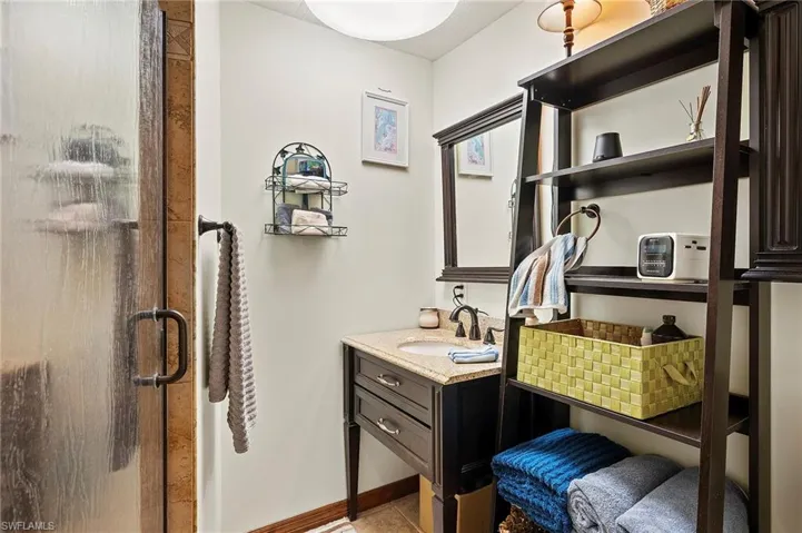 Bathroom featuring vanity and an enclosed shower