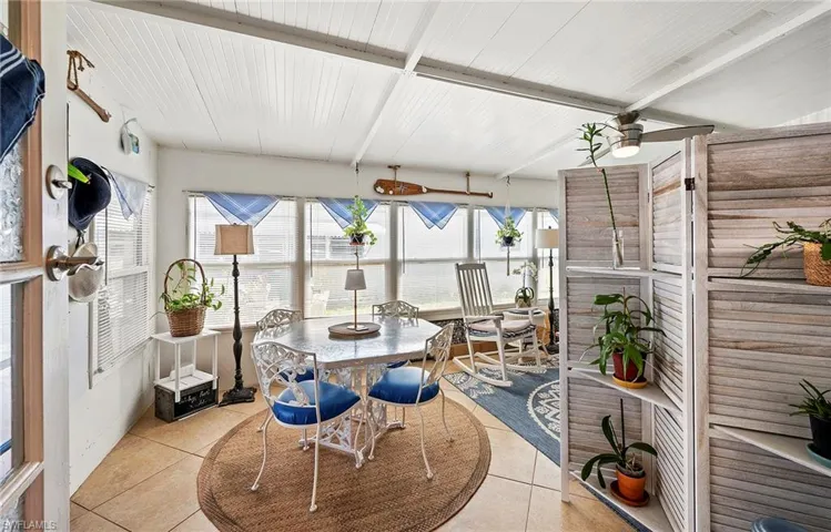 Sunroom / solarium featuring beamed ceiling