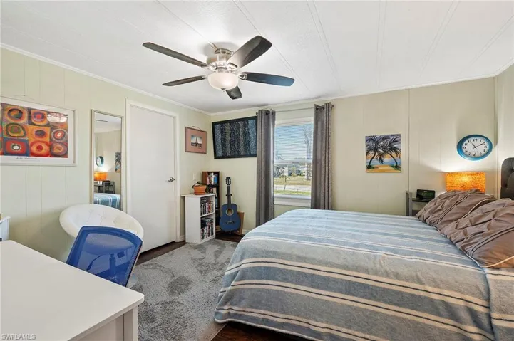 Bedroom with crown molding and ceiling fan