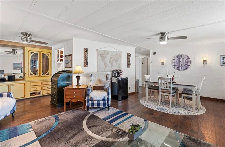 Living room featuring dark hardwood / wood-style floors and ceiling fan