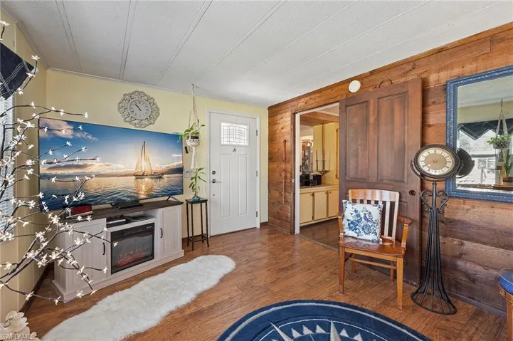 Living room featuring hardwood / wood-style floors and wood walls