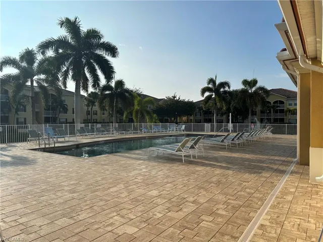 Swimming pool with integrated steps, surrounded by a paver deck