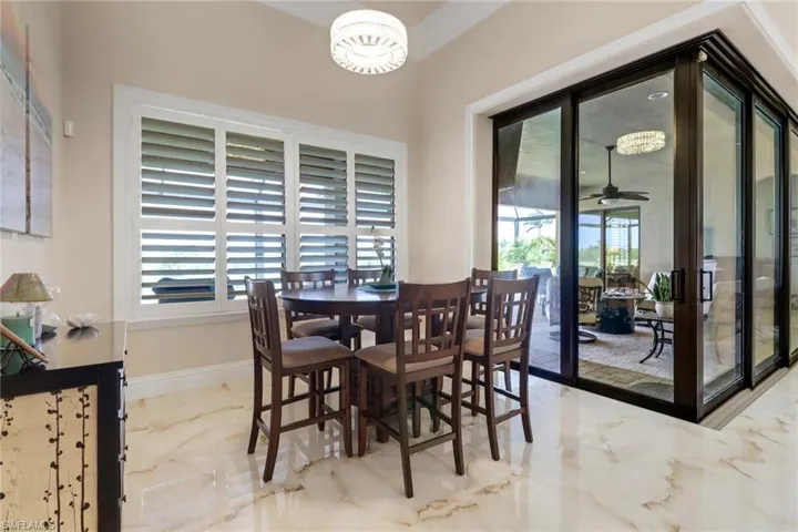 Dining space with marble tiled flooring and ceiling fan
