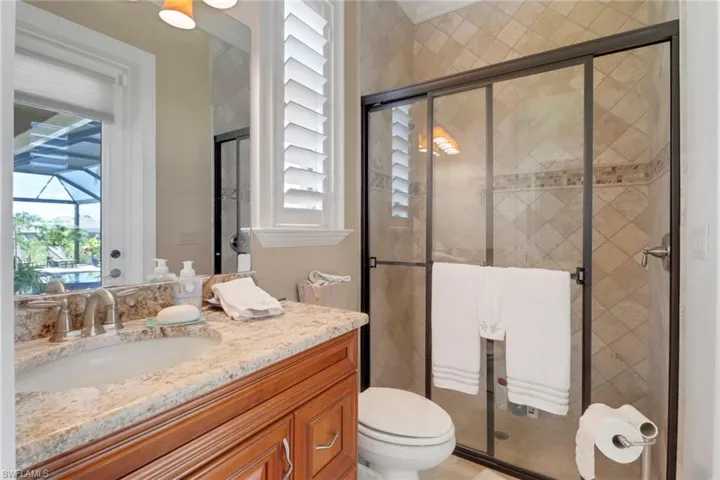Bathroom with vanity and a stall shower