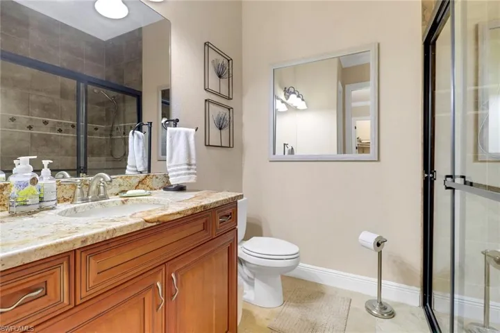 Full bath with a shower stall and vanity