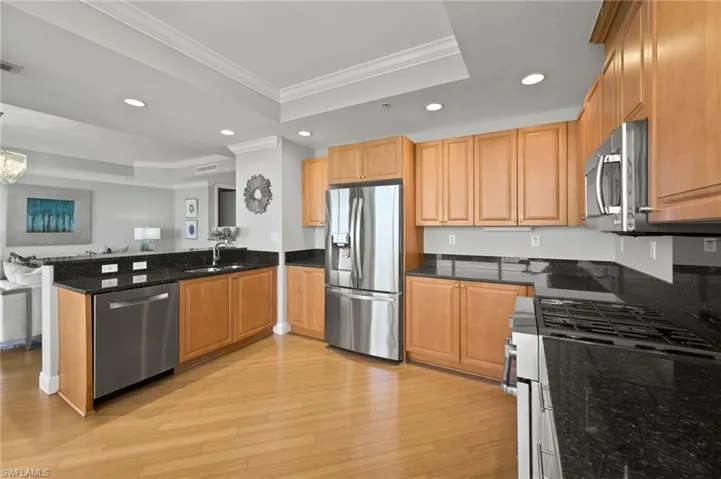 Stainless steel appliances and rich wood cabinetry.