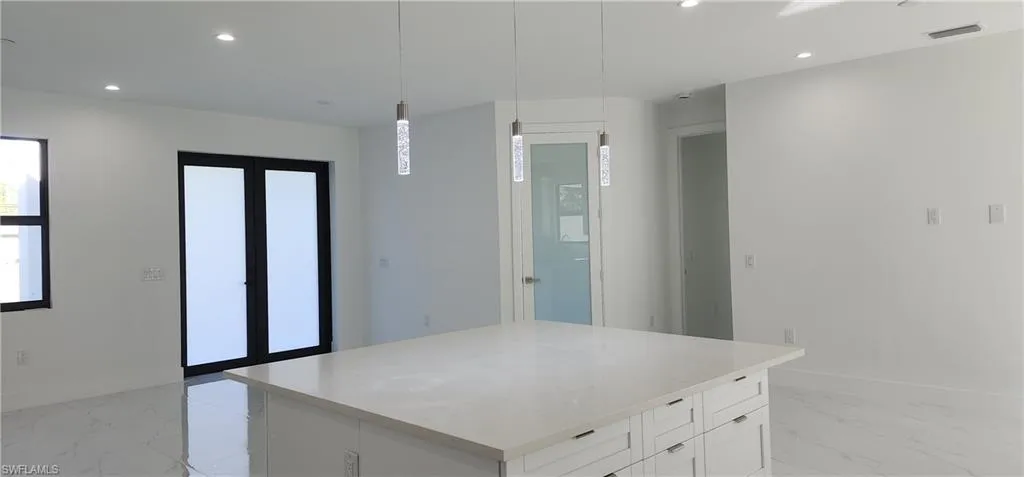 Looking from the kitchen....you see entryway and den