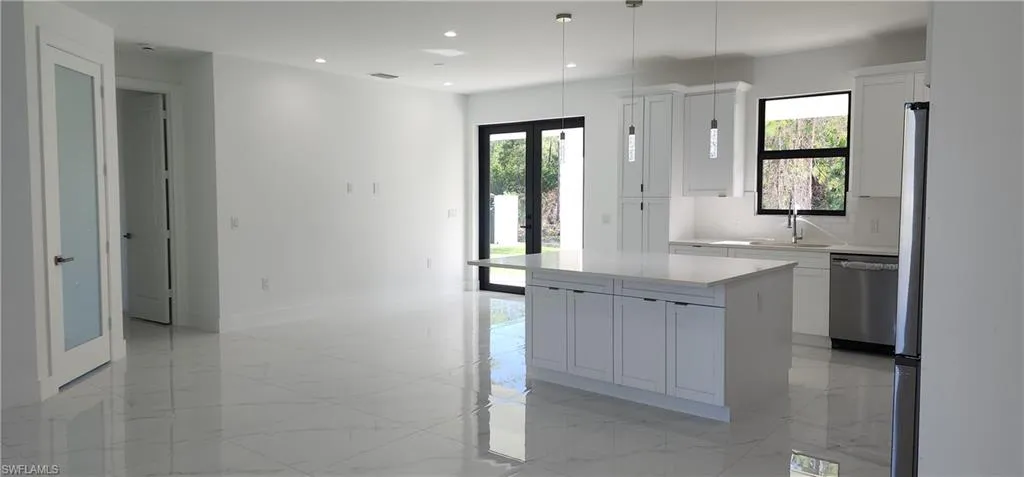 View from living room towards dining room andkitchen with ample light