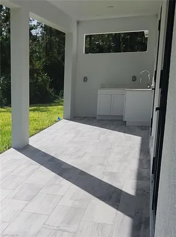 View of patio with cabinets and sink area for entertaining