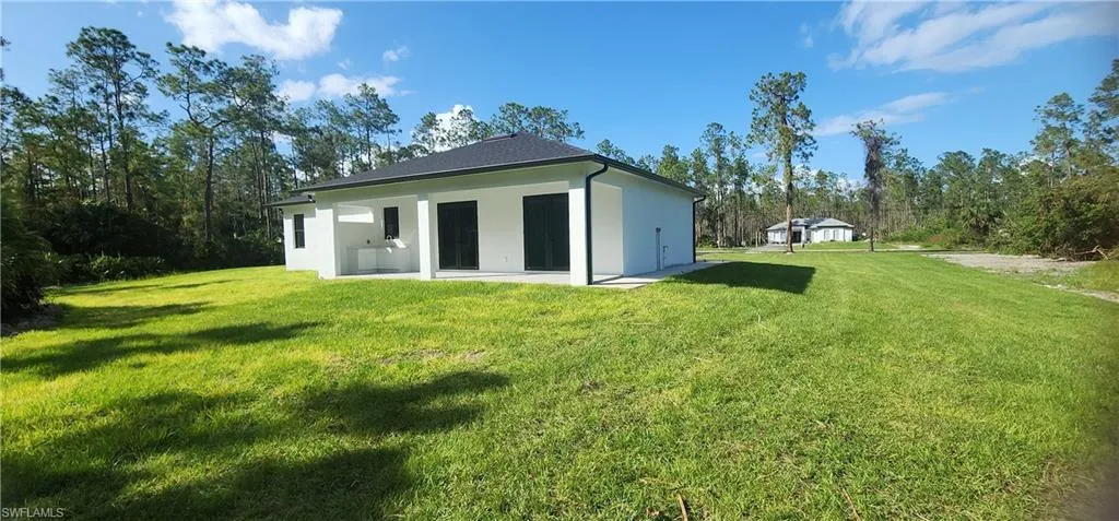 Rear view of property featuring a yard
