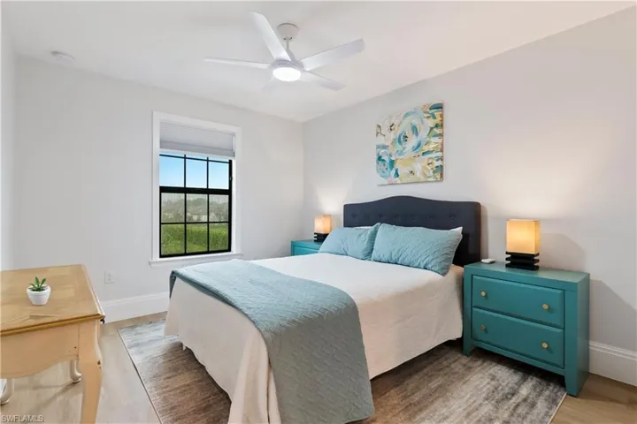 Bedroom with wood finished floors and a ceiling fan