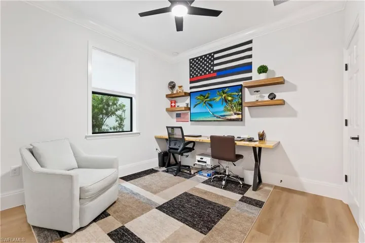 Office featuring crown molding, ceiling fan, and wood finished floors