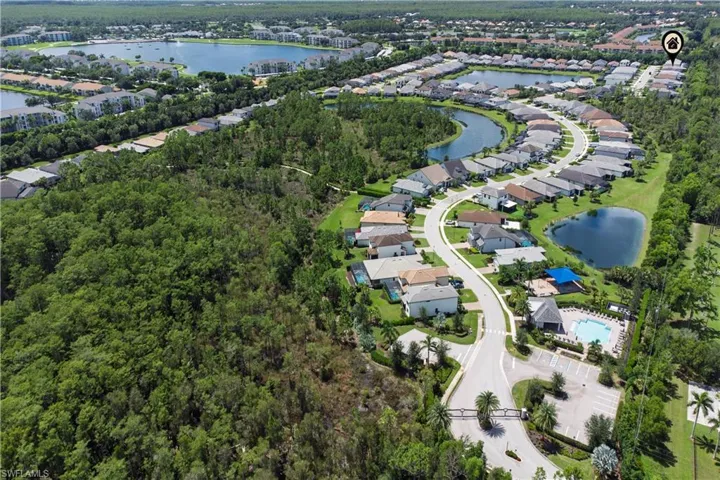 Aerial view of property and surrounding area with a large body of water and nearby suburban area