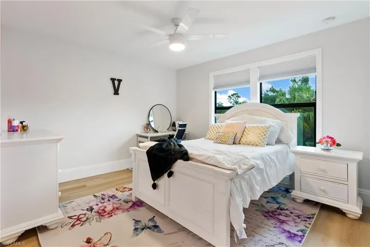 Bedroom with light wood finished floors and ceiling fan