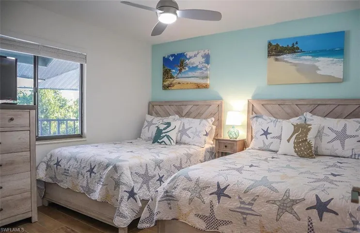 Bedroom with ceiling fan and wood finished floors
