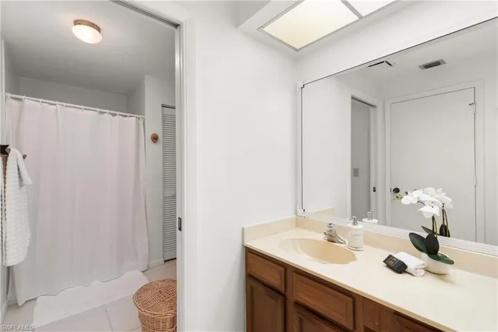 Bathroom featuring tile patterned flooring and vanity