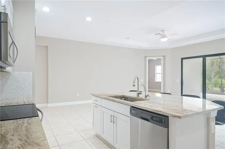 Kitchen with white cabinetry, a healthy amount of sunlight, and stainless steel appliances