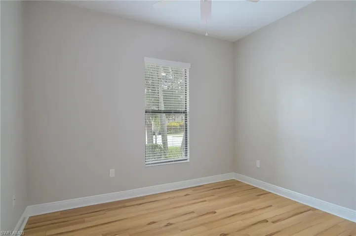 Spare room featuring ceiling fan and light hardwood / wood-style flooring