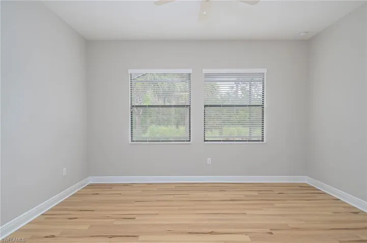Unfurnished room with ceiling fan and light hardwood / wood-style flooring