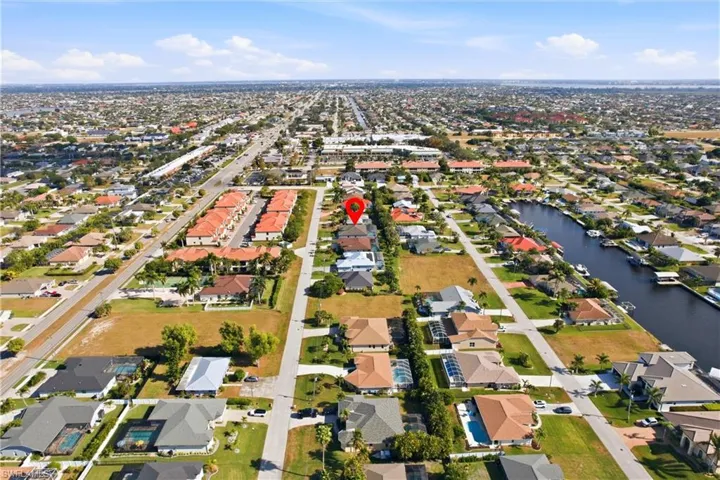 Aerial overview of property's location featuring nearby suburban area