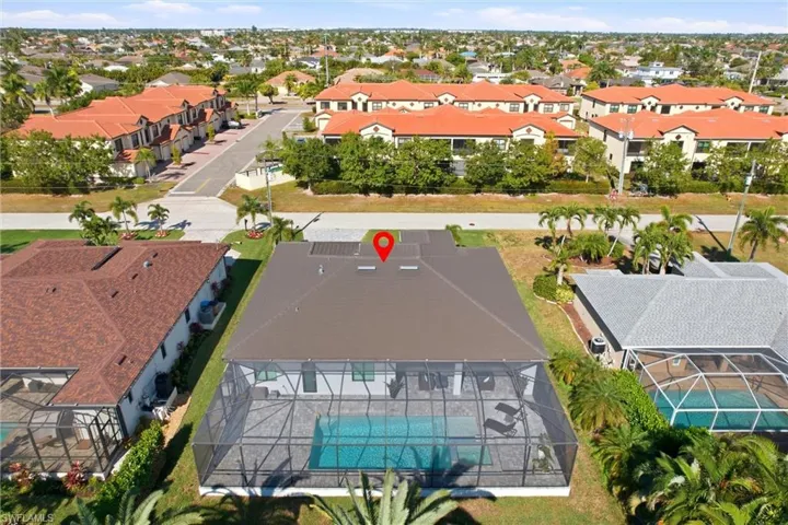 Aerial perspective of suburban area featuring a pool