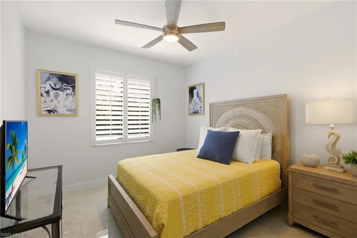 Bedroom with a ceiling fan and baseboards