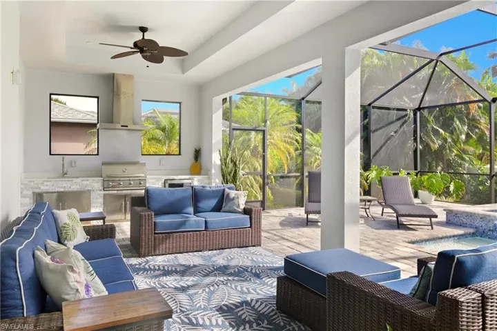 View of patio / terrace with a sunroom, outdoor lounge area, ceiling fan, and glass enclosure