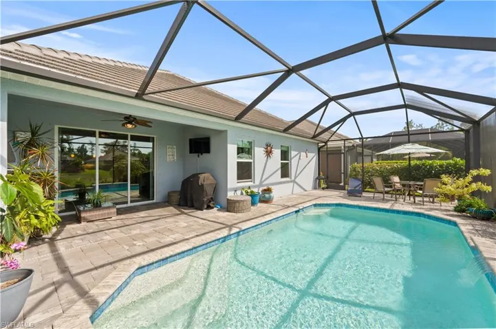 Pool with a patio area, ceiling fan, and a lanai