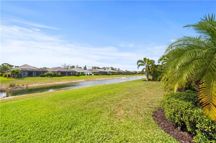 View of yard with a residential view and a water view