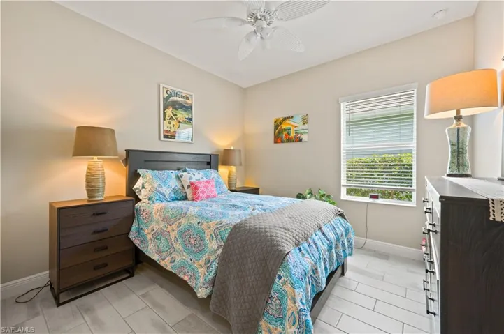 Bedroom featuring ceiling fan and baseboards
