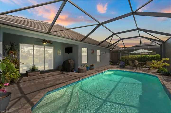 Outdoor pool featuring a patio area, grilling area, a lanai, and ceiling fan