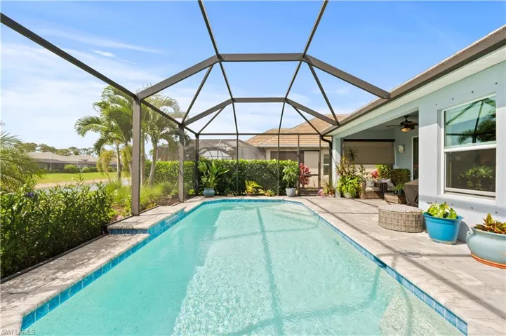 Pool with a ceiling fan, a patio, and glass enclosure