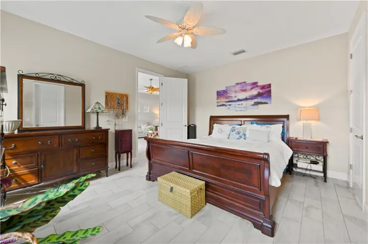 Bedroom with visible vents, baseboards, and a ceiling fan
