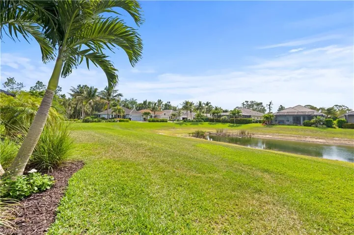 View of yard featuring a residential view and a water view