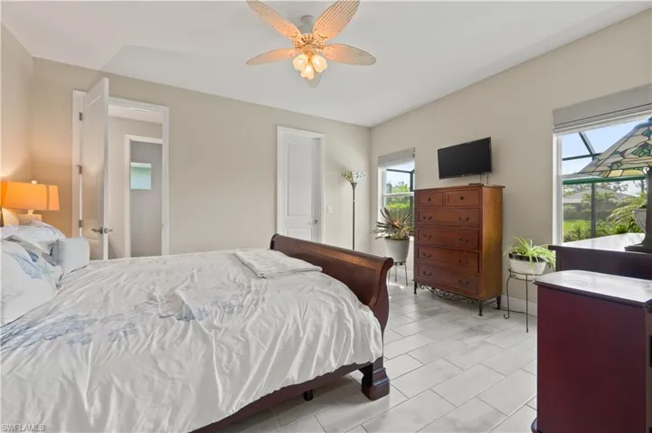 Bedroom featuring multiple windows and a ceiling fan