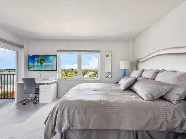 Bedroom with multiple windows, access to exterior, and carpet flooring