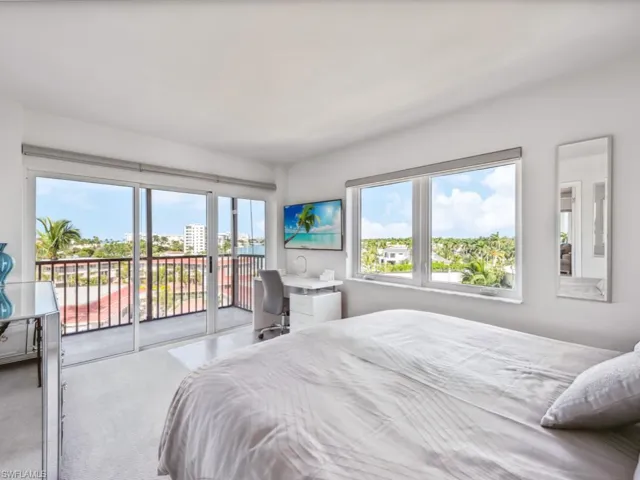Bedroom with carpet floors, access to exterior, and multiple windows