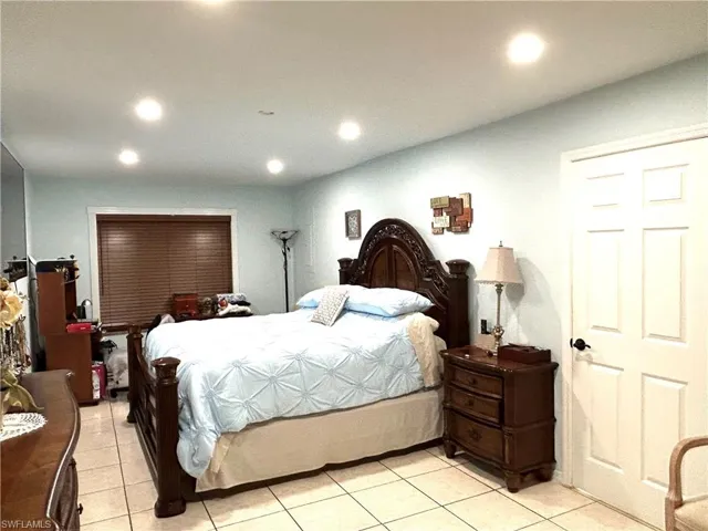 Bedroom with recessed lighting and light tile patterned flooring