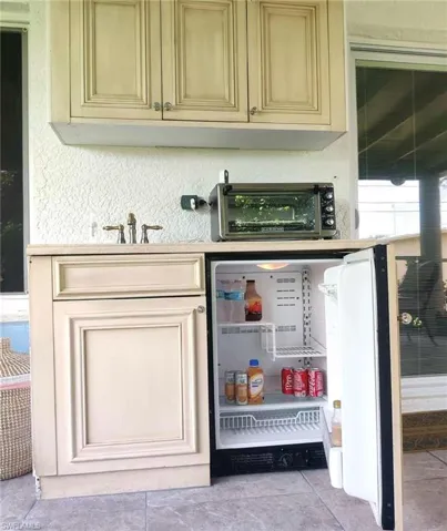 Bar area featuring white fridge