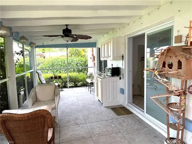 Sunroom / solarium with ceiling fan and beamed ceiling