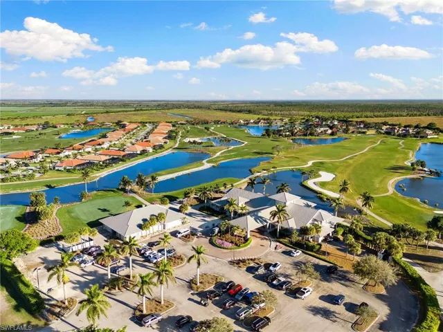 View of property location with a large body of water, nearby suburban area, and a local golf course
