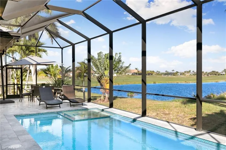 View of pool with glass enclosure and a sunroom