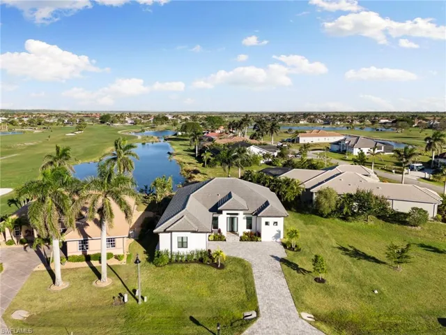 Aerial perspective of suburban area featuring a large body of water and a local golf course