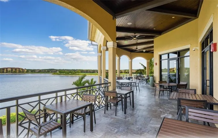 View of patio with outdoor dining space overlooking water.