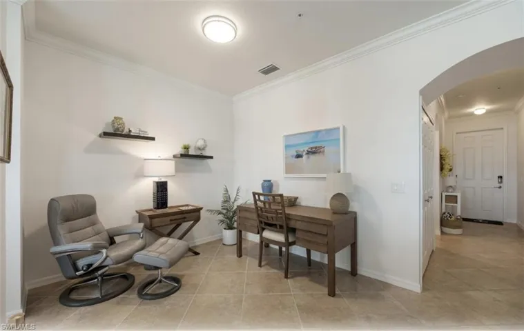 Office/Den  with crown molding, arched walkways, and light tile patterned floors