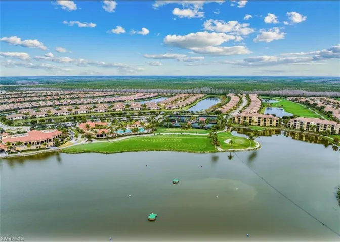 Aerial view of residential area with a large body of water and a golf club